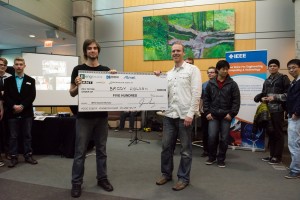 Jason Long presents Brody Holden with the MPG bursary at the UVic wrap-up party on March 26, 2015.