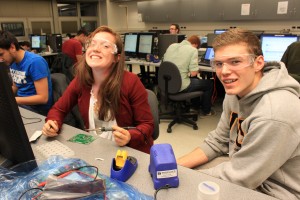 Students having fun soldering at the first MPG at UVic in 2013.